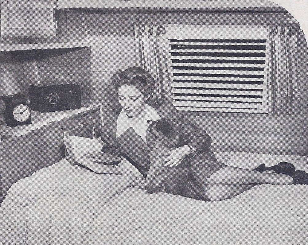 1948 trailer fashion lady reading in trailer on bed