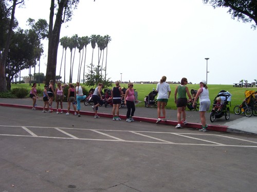 New mothers exercising on the beach with their beautiful babies in their strollers.